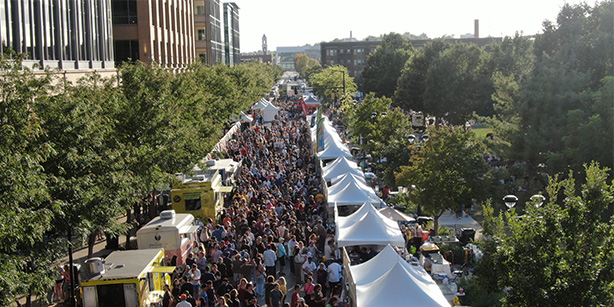 An overhead view of a street filled with people and vendors